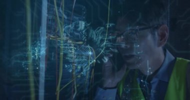 Animation of computer circuit board and digital brain over asian man in server room. Global technology, online security and digital interface concept digitally generated video.