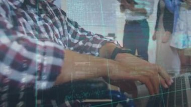 Animation of binary coding and data processing over businessman using laptop in office. Global business, finance, computing and data processing concept digitally generated video.