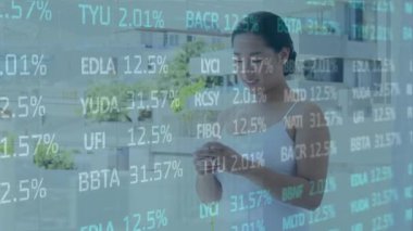Animation of financial data processing over biracial woman using smartphone. Global business, finance, computing and data processing concept digitally generated video.