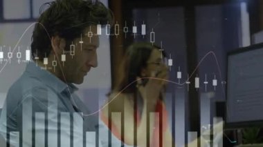 Animation of multiple graphs and numbers on caucasian man working on computer in office. Digital composite, multiple exposure, report, business, digits, abstract and technology concept.