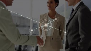 Animation of network of connections with icons over diverse business people in office. Global connections, business, finance, computing and data processing concept digitally generated video.