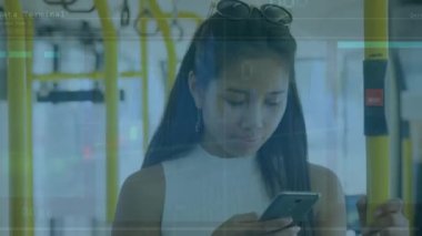 The teenage girl is using her mobile phone on the bus. Global business finance and data processing concept digitally generated video.