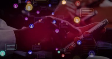 Animation of social media icons with speech bubbles over diverse people using smartphones. Global social media, technology and digital interface concept digitally generated video.