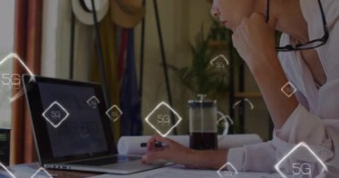 Animation of 5g texts over caucasian woman using laptop. Global business and digital interface concept digitally generated video.