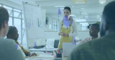 Animation of data processing over biracial female fashion designer discussing with her colleagues. Business data technology concept