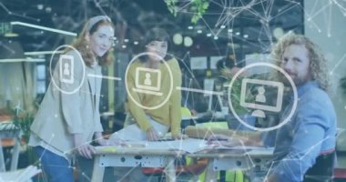 Animation of network of connections with icons over diverse business people working at office. Global business, finances and digital interface concept, digitally generated video.