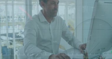 Animation of financial data processing over caucasian businessman using computer in office. Global networks, computing, business, finance and data processing concept digitally generated video.