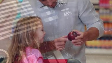 Animation of data processing over caucasian man showing a fruit to his daughter at a grocery store. Business data technology concept