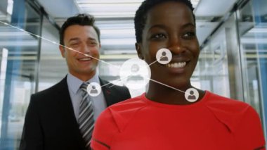 Animation of network of connections with icons over diverse business people working at office. Global business, connections and digital interface concept digitally generated video.