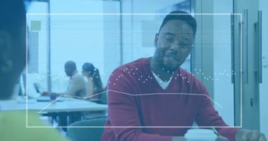 Animation of financial data processing over african american businessman in office. Global business, finance, computing and data processing concept digitally generated video.