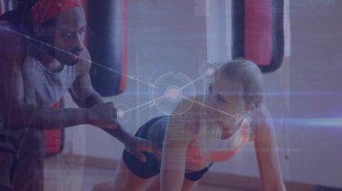 Animation of data processing over caucasian woman exercising with male coach. Global sports, exercise, computing and data processing concept digitally generated video.