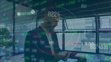 Animation of financial data processing and scope over businessman using smartphone. Global networks, computing, business, finance and data processing concept digitally generated video.