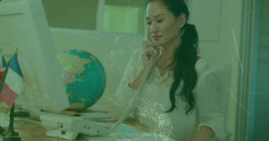 A woman is talking on the phone in a business setting. Global business and digital interface concept digitally generated video.