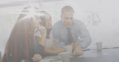 Animation of light spots over diverse business people in office. Global business and digital interface concept digitally generated video.