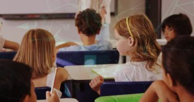 Animation of shapes moving over diverse schoolchildren in classroom. Global education and digital interface concept digitally generated video.