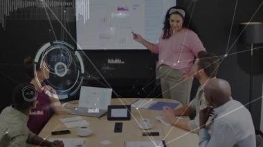 Animation of circles and connected dots against diverse coworkers discussing reports on technology. Digital composite, multiple exposure, teamwork, communication, business and abstract concept.