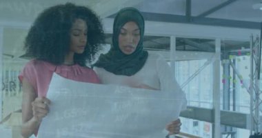 Animation of financial data processing over diverse businesswomen in office. Global business, finance, computing and data processing concept digitally generated video.