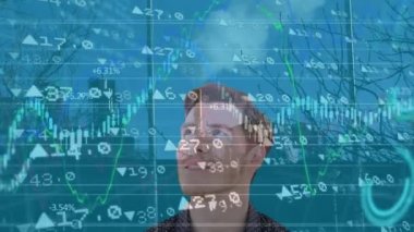 Animation of financial data processing over caucasian man and cityscape. Global business, finances and digital interface concept digitally generated video.