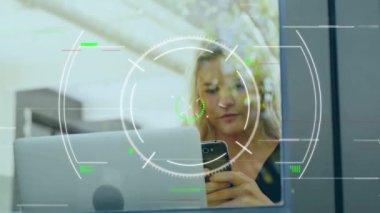 Animation of scope scanning over caucasian businesswoman using smartphone at office. Global business, finances and digital interface concept digitally generated video.