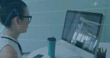 Animation of graphs with numbers over caucasian woman watching video on laptop and writing in book. Digital composite, multiple exposure, report, finance, growth, business and technology concept.