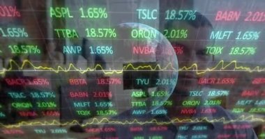 Animation of financial data processing over globe and businessman working in office. Global computing, finance, business and data processing concept digitally generated video.