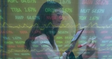 Animation of data processing and globe over caucasian businesswoman working in office. Global business and digital interface concept digitally generated video.