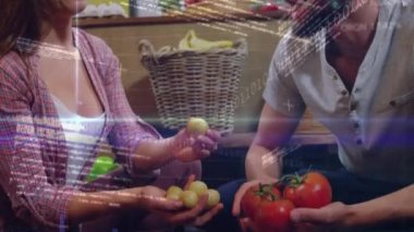 Animation of financial data processing over caucasian couple at grocery store. Global business, finances and digital interface concept digitally generated video.