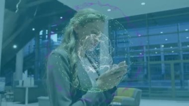 Animation of globe with connections over caucasian businesswoman using smartphone. Global connections, business, finance, computing and data processing concept digitally generated video.