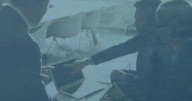 Animation of statistical data processing over diverse businesspeople discussing over digital tablet. Business data technology concept