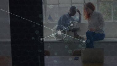 Animation of network of connections over diverse businesswomen talking in office. Global business, finance, computing and data processing concept digitally generated video.