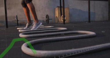 Animation of data processing over woman exercising. Global sports, active lifestyle, computing and data processing concept digitally generated video.