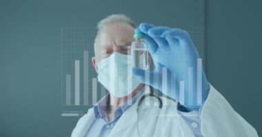 Animation of bar graphs moving over senior caucasian doctor in mask shaking liquid filled vial. Digital composite, multiple exposure, investment, protection, research, medical and healthcare.