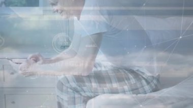 Animation of financial data processing over caucasian man using smartphone. Global business, finance, computing and data processing concept digitally generated video.