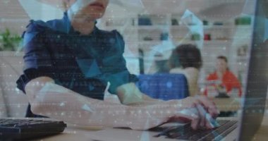 Animation of particles and geometric shapes over caucasian woman working over laptop at office. Digital composite, multiple exposure, illuminated, communication, abstract and technology concept.