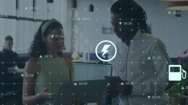 Animation of digital icons and data processing over diverse man and woman discussing at office. Business technology concept