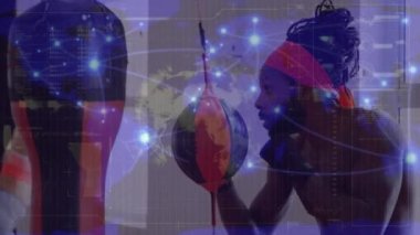 Animation of globe, connected dots, loading bars, african american male boxer practicing on punchbag. Digital composite, multiple exposure, globalization, progress, sports and competition concept.
