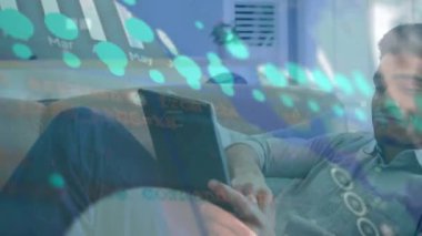 Animation of data processing over man with tablet. Global computing, finance, business and data processing concept digitally generated video.