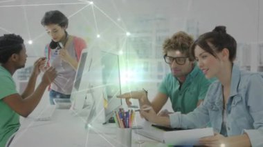 Animation of network of connections over diverse team of graphic designers discussing at office. Global networking and creative business technology concept