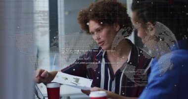 Animation of globe and data processing over diverse men discussing over a document at office. Global networking and business technology concept