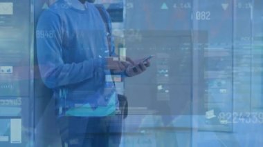 Animation of financial data processing over man using smartphone. Global business, finances, computing and data processing concept digitally generated video.