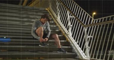 Animation of data processing over caucasian man doing up shoe laces during running. Global sports, active lifestyle, computing and data processing concept digitally generated video.
