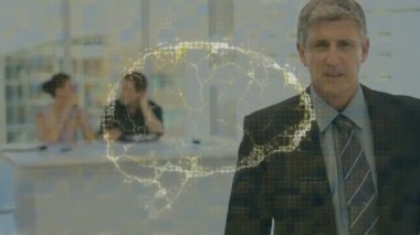 Animation of human brain icon spinning over caucasian senior businessman smiling at office. Medical research and business technology concept