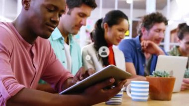 Animation of network of connection with icons over diverse business people using electronic devices. Global business, computing, connections and data processing concept digitally generated video.