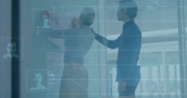 Animation of graphs, digital portrait of people over diverse coworkers examining blueprint in office. Digital composite, multiple exposure, report, business, discussion, teamwork and abstract.