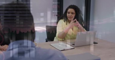 Animation of financial data processing over diverse businesswomen in office. Global business, finance, computing and data processing concept digitally generated video.