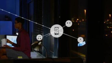 Animation of network of connections with icons over diverse business people working at office. Global business, connections and digital interface concept digitally generated video.