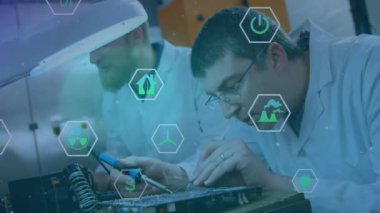 Animation of icons and snow falling over diverse male scientists in lab. Global science, finances and digital interface concept, digitally generated video.