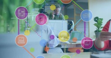 Animation of media icons over diverse business people in office. Global business and digital interface concept digitally generated video.