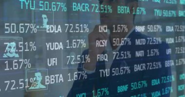 Animation of stock market data processing over thoughtful biracial businessman at office. Global economy and business technology concept