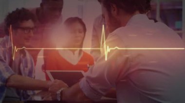 Animation of cardiograph over diverse business people in office. Global business and digital interface concept digitally generated video.